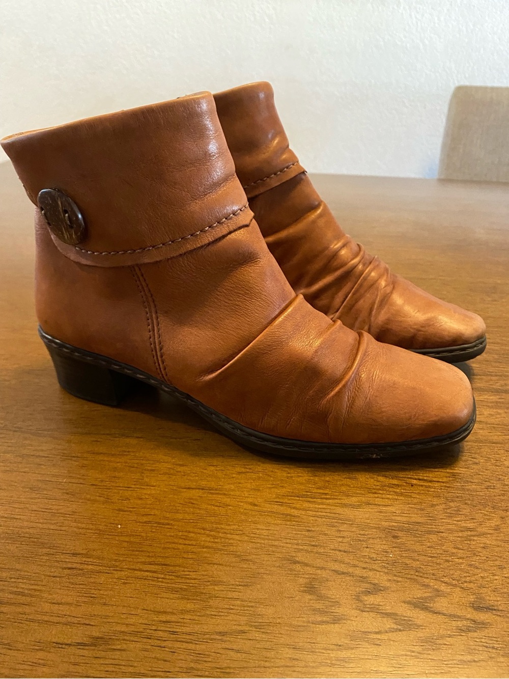 Rieker ankle boots featuring a distinctive decorative button detail